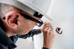 electrician working on electrical outlet