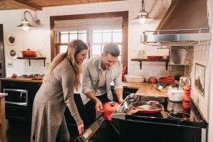 man and woman cooking with residential oven