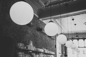 black and white image of lights in a brick restaurant